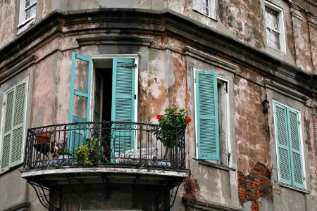 Balcony with open blue French doors leading inside