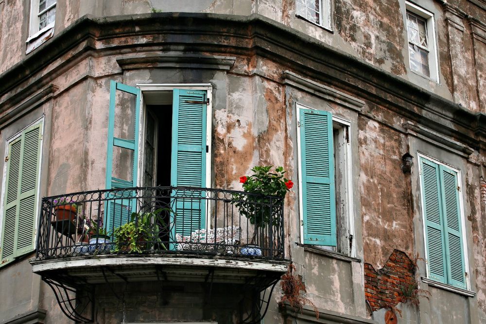 Balcony with open blue French doors leading inside