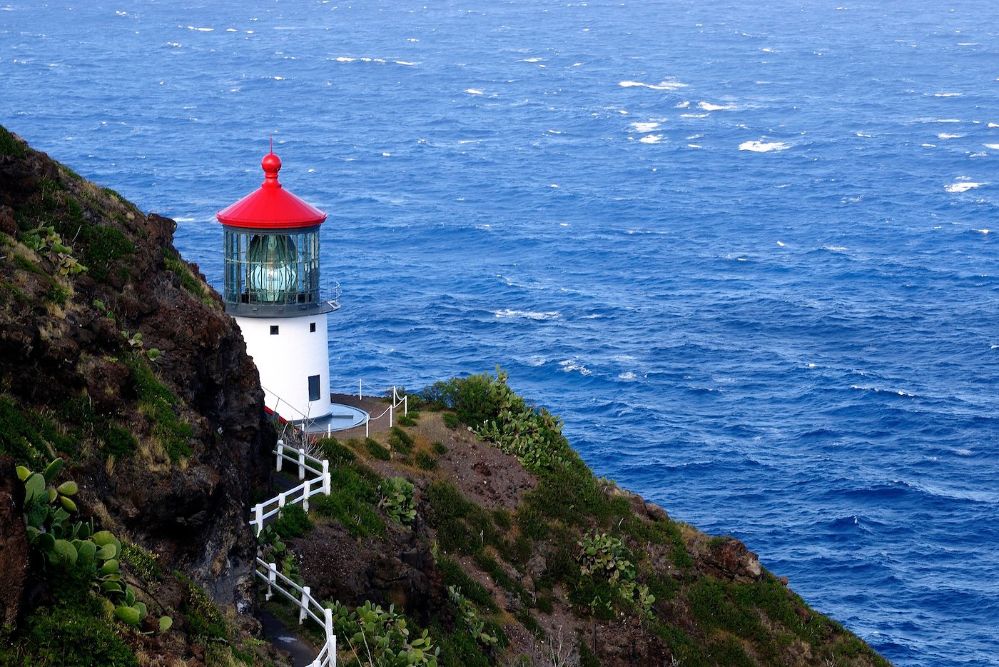 High Angle View Of Lighthouse On Cliff By Sea