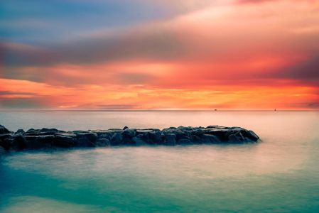 Scenic View Of Sea Against Sky At Sunset