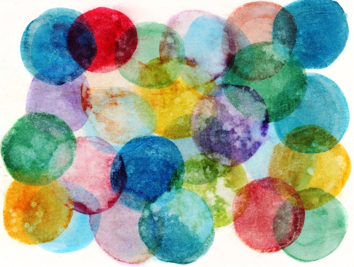 Hand painted circles of multiple colors on a white background