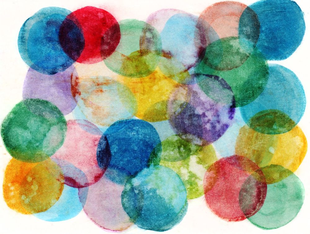 Hand painted circles of multiple colors on a white background