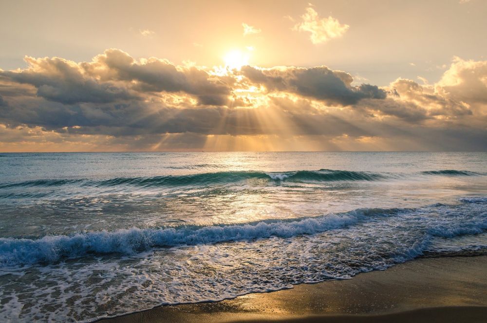 Scenic View Of Beach Against Sky During Sunset