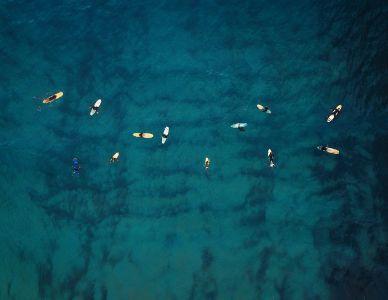 Aerial view of a group of surfers. Abstract Background.