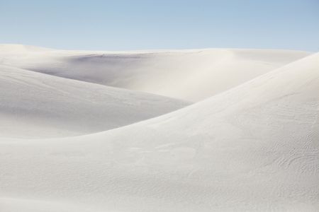 Rolling white sand dunes on a sunny day at White Sands National 