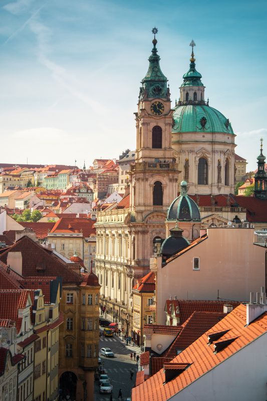 Orange roofs of Prague Old Town and town square with tourists se